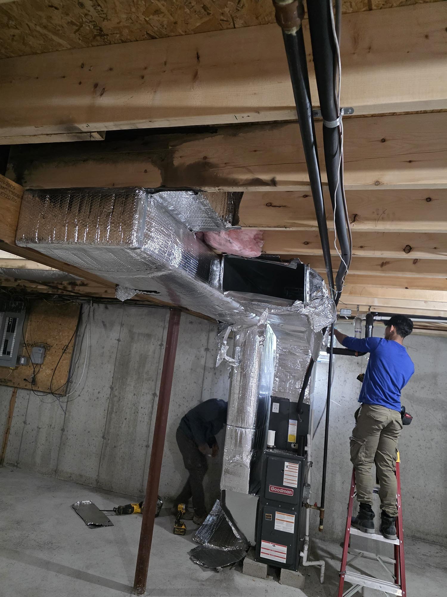 AIRMAX technician working on a residential HVAC installation
